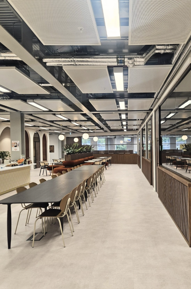 Butternut Box communal dining area with long tables and modern industrial ceiling