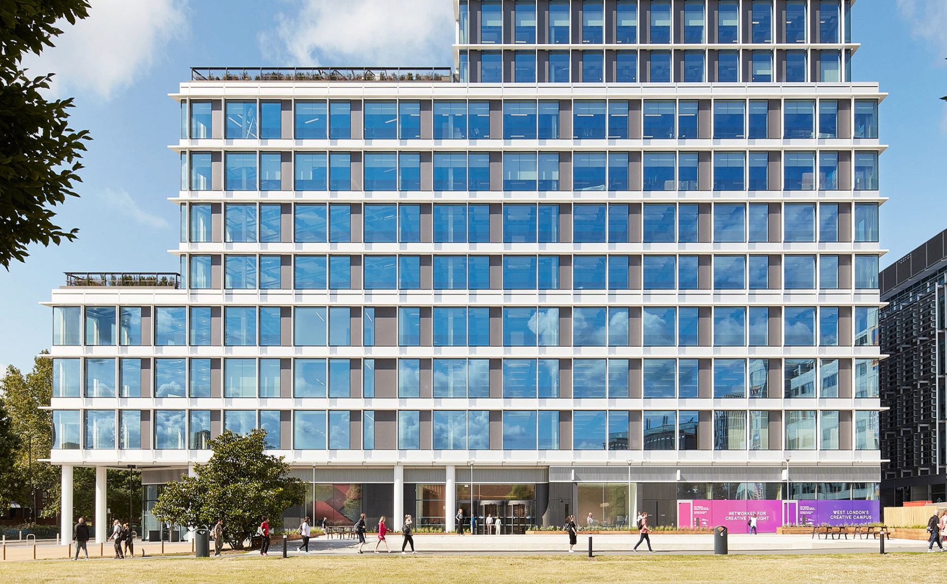 Gateway Central building at White City Place - modern glass office building with people walking outside